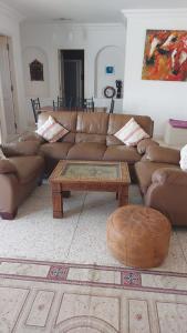a living room with couches and a coffee table at Club Evasion in Tamelalt