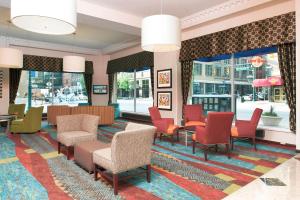 a lobby with colorful chairs and tables and windows at Hampton Inn Indianapolis Downtown Across from Circle Centre in Indianapolis