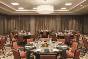 a conference room with tables and chairs and a chandelier at Home2 Suites By Hilton Phoenix-Tempe University Research Park in Tempe