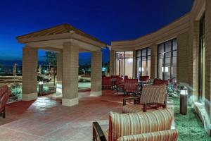 a patio with chairs and a gazebo at night at Hilton Garden Inn Pittsburgh/Cranberry in Cranberry Township