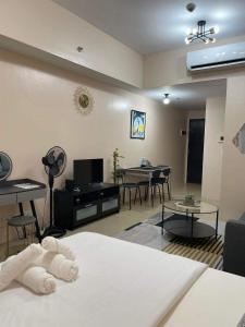 a living room with a bed and a living room with a dining room at studio condo building 81 newport boulevard in Manila