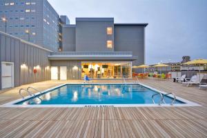 a swimming pool on the roof of a building at Home2 Suites by Hilton Dallas Downtown at Baylor Scott & White in Dallas