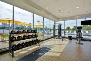 a fitness room with a lot of windows at Home2 Suites by Hilton Dallas Downtown at Baylor Scott & White in Dallas