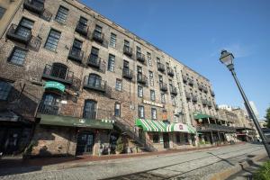 a large brick building on a city street at The Cotton Sail Hotel Savannah - Tapestry Collection by Hilton in Savannah