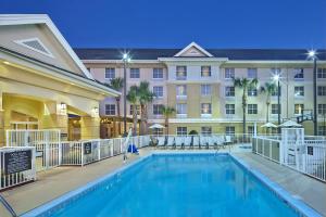 a swimming pool in front of a hotel at Homewood Suites by Hilton Daytona Beach Speedway-Airport in Daytona Beach
