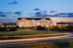 a large building with a road in front of it at Hilton Garden Inn Dulles North in Ashburn