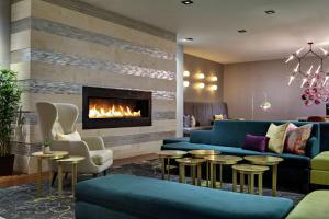 a living room with a couch and a fireplace at DoubleTree by Hilton Fairfield Hotel & Suites in Fairfield