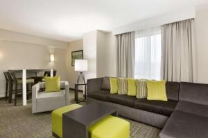 a living room with a couch and a table at Embassy Suites Newark - Wilmington/South in Newark
