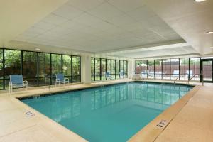 a large swimming pool with blue water in a building at Homewood Suites by Hilton Newark-Wilmington South Area in Newark