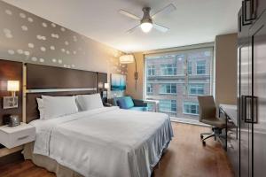 a bedroom with a bed and a desk and a window at Homewood Suites Midtown Manhattan Times Square South in New York