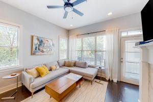 a living room with a couch and a ceiling fan at City View in Atlanta