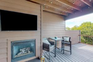 a screened porch with a table and a tv on a fireplace at City View in Atlanta