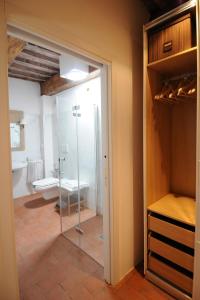 a glass door leading into a bathroom with a shower at Fattoria il Leccio Fienile on Florence Hills in Fiesole