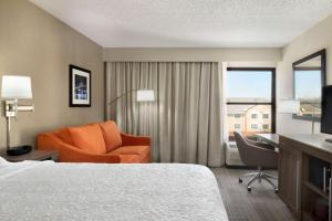 a hotel room with a bed and a desk and a chair at Hampton Inn Philadelphia/Mt. Laurel in Mount Laurel