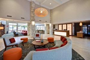 a living room with a couch and a table at Homewood Suites by Hilton - Oakland Waterfront in Oakland