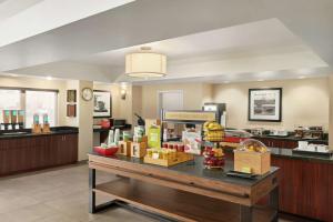 a lobby with a counter with food on it at Hampton Inn Portland Airport in Portland