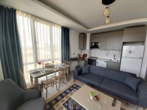 a living room with a couch and a table at Ethica Suite Luxury Houses in Aksu
