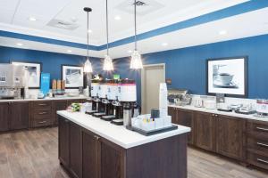 a restaurant with a counter with bottles of wine at Hampton Inn Kennebunk Kennebunkport Me in Kennebunk