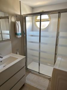 bagno con doccia e porta in vetro di Apartamentos Turísticos Yamasol a Fuengirola