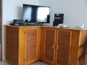a television sitting on top of a wooden cabinet at 212 Goldenview in Saint James