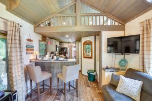 a kitchen and living room in a tiny house at Mayfield Tiny Home with Porch, Walk to Beaches! in Benson