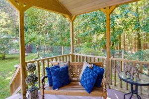 a wooden gazebo with a bench on a porch at Mayfield Tiny Home with Porch, Walk to Beaches! in Benson