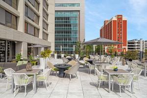 a patio with tables and chairs and buildings at Hilton Birmingham Downtown at UAB in Birmingham