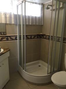 a shower stall in a bathroom with a toilet at 104 Santana Resort, Margate Beach in Margate