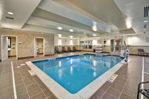 a large swimming pool in a hotel room at Hilton Garden Inn Detroit Troy in Troy
