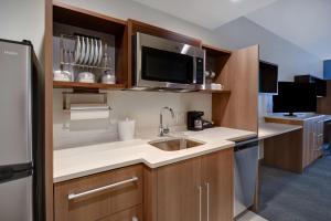 a kitchen with a sink and a microwave at Home2 Suites by Hilton Troy in Troy
