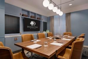 a conference room with a large wooden table and chairs at DoubleTree by Hilton New York Downtown in New York