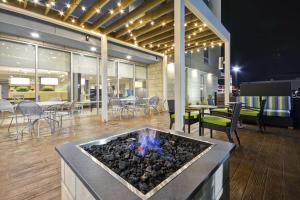 a lobby with a fire pit and tables and chairs at Home2 Suites By Hilton Rock Hill in Rock Hill