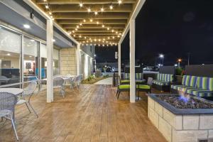 an outdoor patio with chairs and tables and lights at Home2 Suites By Hilton Rock Hill in Rock Hill