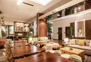 a lobby of a hotel with tables and couches at Hilton Garden Inn Seattle Downtown in Seattle