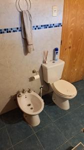 a bathroom with a toilet and a bidet at Simple y cálido departamento in Maipú