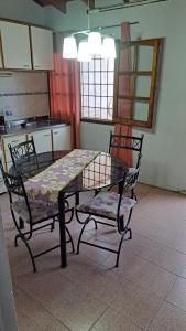 a table and two chairs in a kitchen at Simple y cálido departamento in Maipú