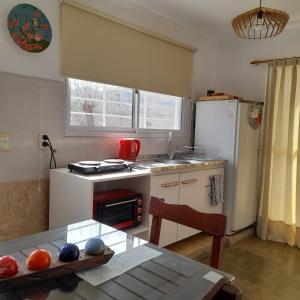 a kitchen with a table and a stove and a refrigerator at Bella Vista in Valle Hermoso +6 photos