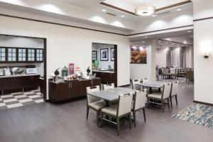 a restaurant with tables and chairs in a room at Hampton Inn & Suites Chicago North Shore in Skokie