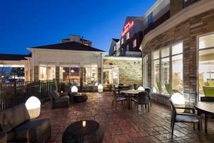 a patio with tables and chairs outside of a building at Hilton Garden Inn Cincinnati/Mason in Mason