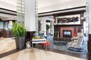 a lobby of a hotel with a fireplace at Hilton Garden Inn Cincinnati/Mason in Mason