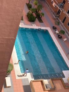 una vista sul tetto di una piscina con 2 persone di Ría de Huelva a Huelva