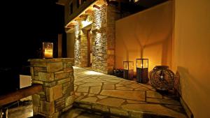a stone walkway with lights on the side of a building at Lions Nine in Mouresi