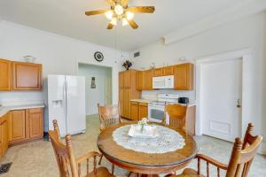 a kitchen with a table and chairs and a refrigerator at Paris Vacation Rental about 15 Mi to Mount Magazine! in Paris