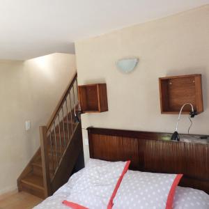 a bedroom with a bed and a staircase at Gite Mas Des Combes in Mandagout