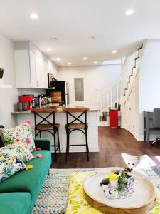 a living room with a green couch and a table at Charming 1BDR In Central Rittenhouse Square With Patio Hosted by StayRafa in Philadelphia