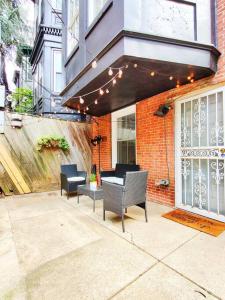a patio with chairs and a table and a building at Charming 1BDR In Central Rittenhouse Square With Patio Hosted by StayRafa in Philadelphia