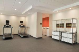 a gym with two elliptical machines and towels at Home2 Suites by Hilton Milwaukee Airport in Milwaukee