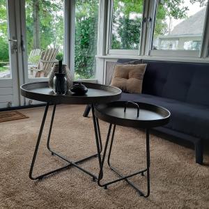 two tables in a living room with a couch at Tuinkamer 't Strunerke in Augustinusga