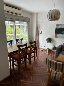 a living room with a dining room table and chairs at Belgrano Lujoso Semipiso Panorámico 2 habitaciones cocina independiente lavadero cochera privada a metros del subte y de Fleming in Buenos Aires +71 photos