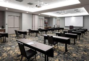 a classroom with tables and chairs and a projection screen at Hilton Garden Inn Madison Downtown, WI in Madison